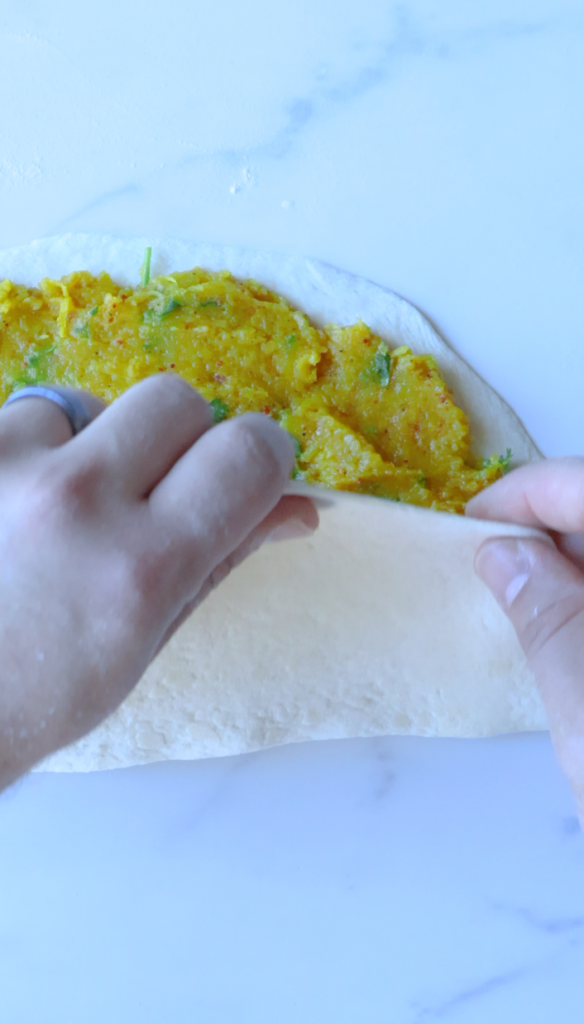 Roll dough into circles, add filling, and fold over sealing the dough.